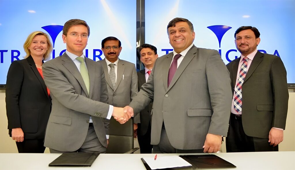 Fadi Mitri and UGDC CEO Ghiyas Paracha shake hands after signing ceremony at Trafigura’s Geneva HQ.